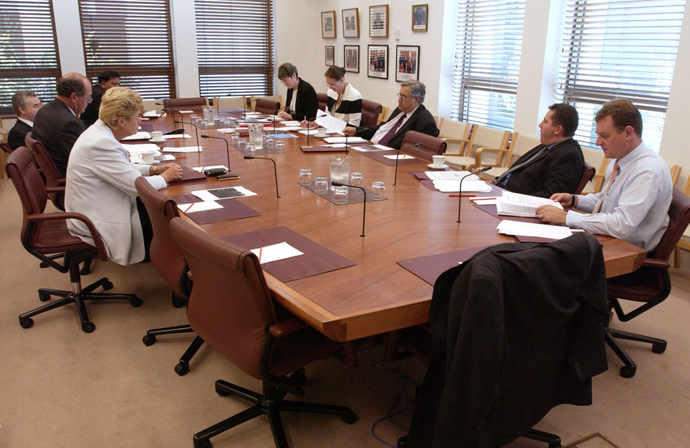 Standing Committee of Privileges in session, 4 March 2001. Clockwise around table from left: Senators Sue Knowles [Deputy Chair], David Johnston and Gary Humphries (obscured), Banuera Berina [Chair of the Privileges Committee of the Republic of Kiribati] (obscured), June Nelson [Executive Assistant], Rosemary Laing [Acting Secretary], Senators Robert Ray [Chair], Chris Evans and Nick Sherry. DPS Auspic.
