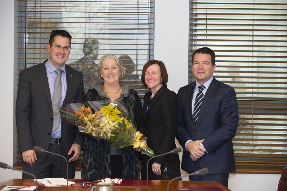 Senator Sue Boyce receiving flowers from members of the Standing Committees on Community Affairs upon her retirement from the Senate, 24 June 2014. L-R: Senators Zed Seselja, Sue Boyce [Chair, Legislation], Rachel Siewert [Deputy Chair, Legislation] and Dean Smith. DPS Auspic.