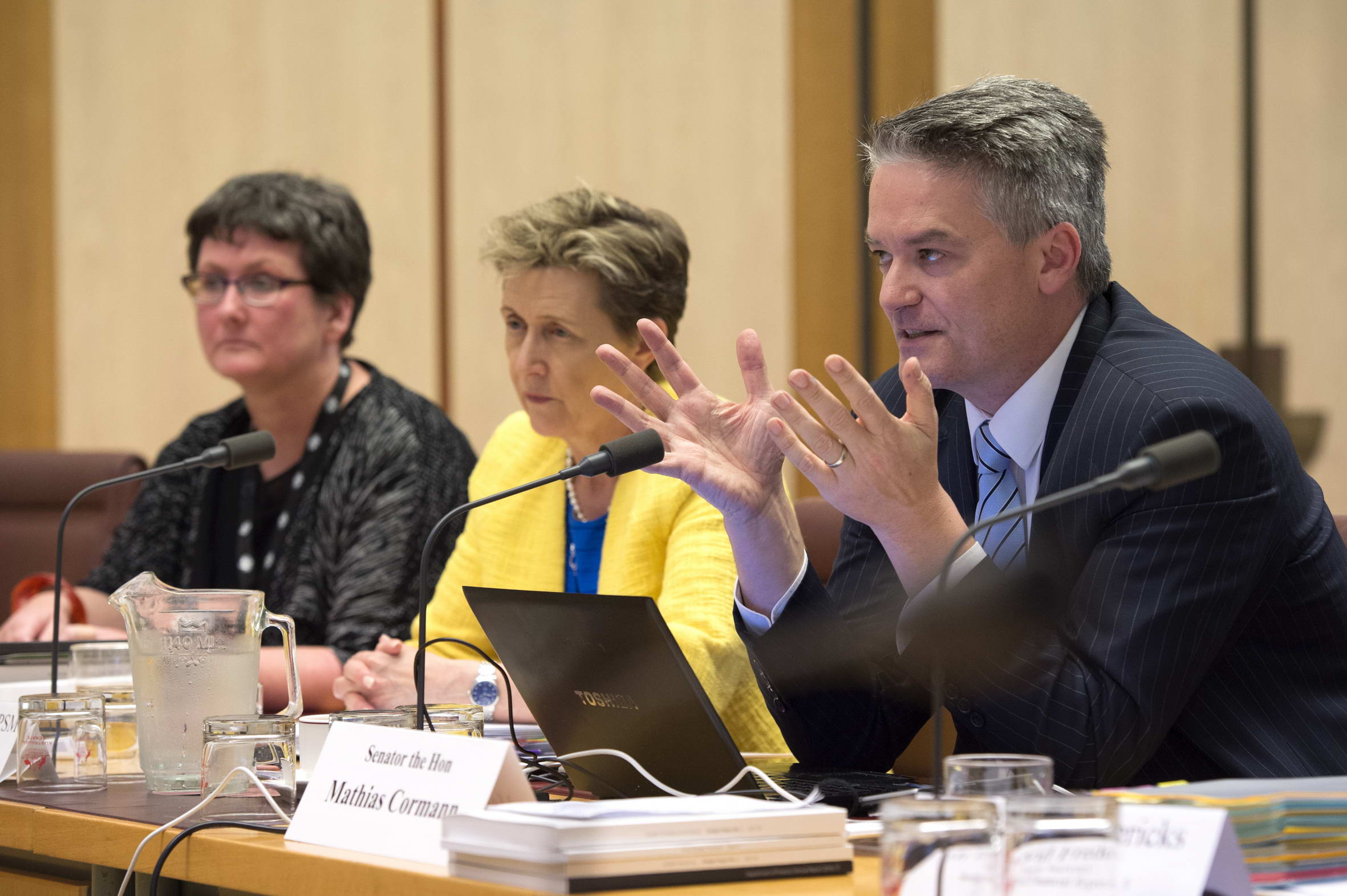 Senator the Hon Mathias Cormann, Minister for Finance, answering questions at the hearing, 24 October 2017, with Amanda Lee [left, First Assistant Secretary, Budget and Financial Reporting, Department of Finance] and Rosemary Huxtable [Secretary, Department of Finance]. DPS Auspic.