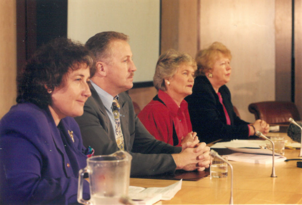 Committee chair Senator Jocelyn Newman speaking at the report launch, 31 August 1994. L-R: Senators Christabel Chamarette, Shayne Murphy [Deputy Chair], Jocelyn Newman [Chair] and Kay Denman. DPS Auspic.
