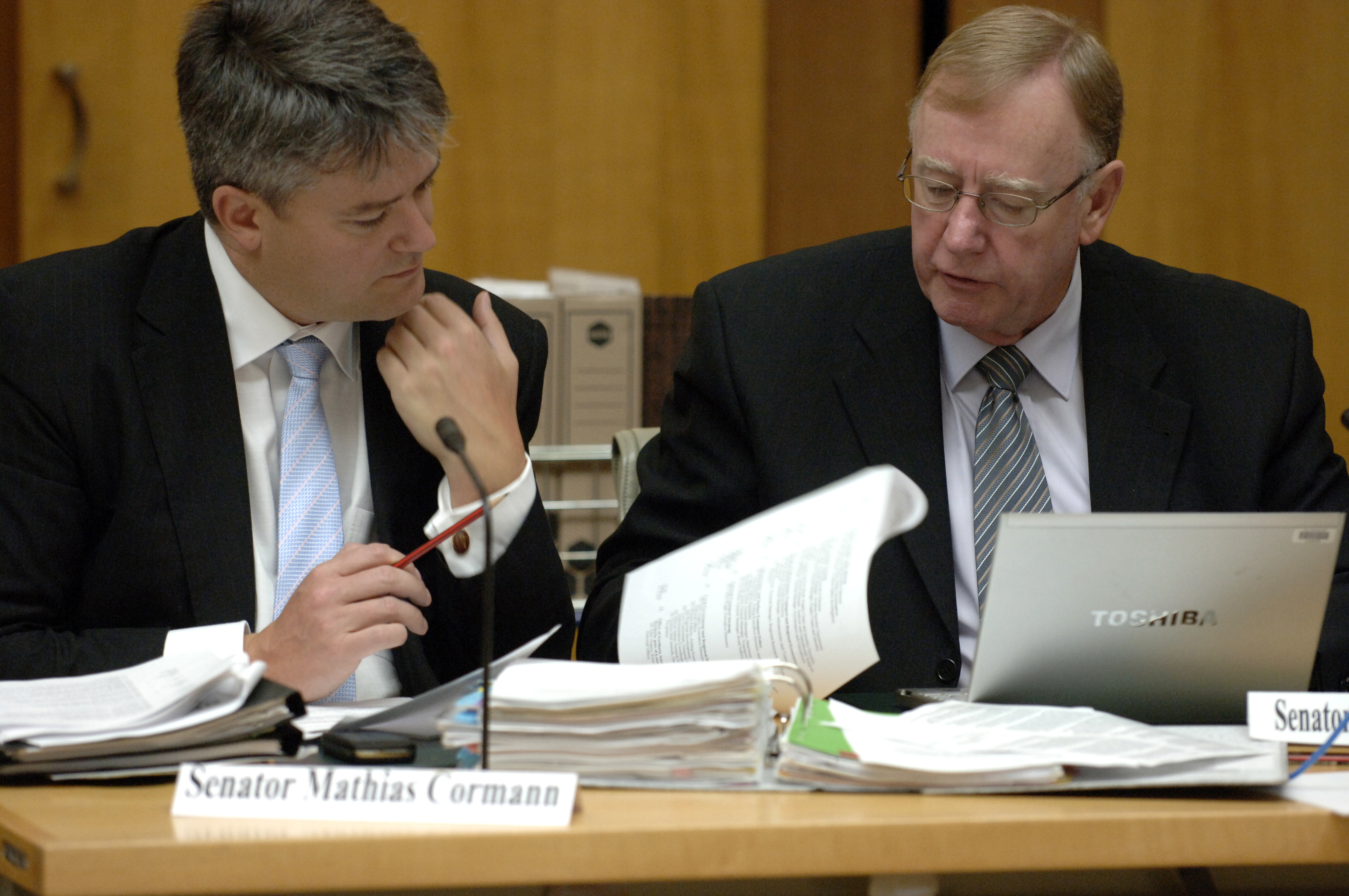 \x3cp\x3eCommittee members Senators Mathias Cormann and Ian Macdonald examining documents, additional estimates hearing, 24 February 2009. DPS Auspic.\x3c/p\x3e