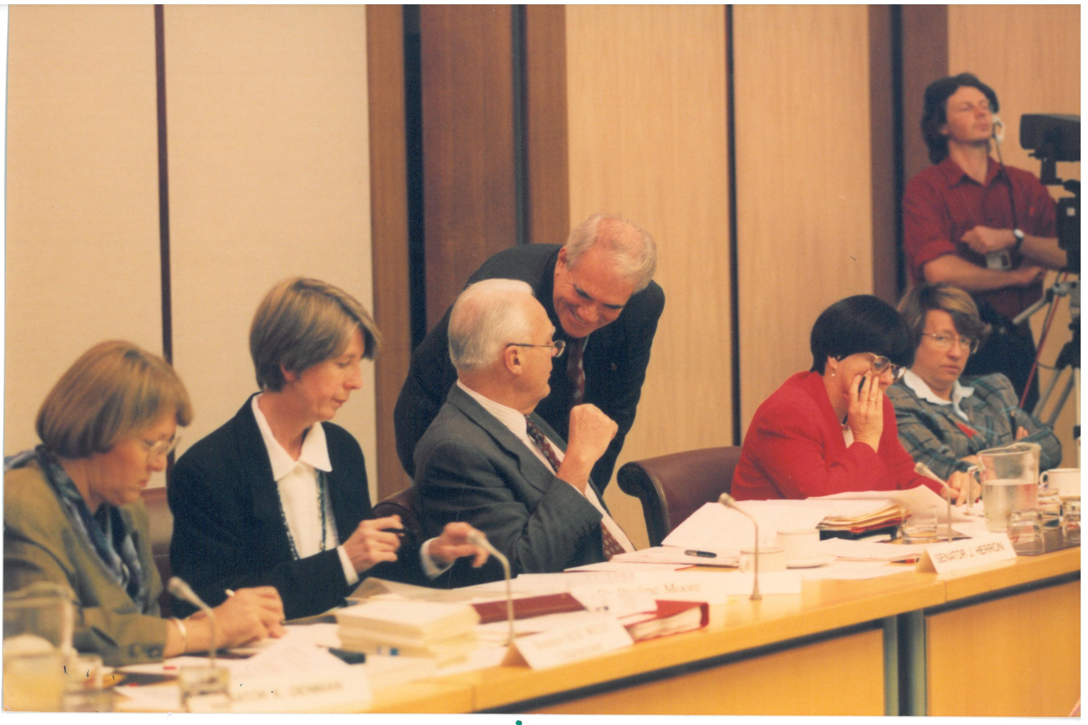 \x3cp\x3eMembers of the Senate Community Affairs Legislation Committee hearing evidence from witnesses at a public hearing of its inquiry into the Supported Accommodation Assistance Bill 1994 and the Supported Accommodation Assistance Amendment Bill 1994, 1 December 1994. Seated L-R: Senator Sue West [Chair], Dr Pauline Moore [Secretary], Senators John Herron, Grant Tambling, Kay Patterson and Meg Lees [Deputy Chair].\x3c/p\x3e