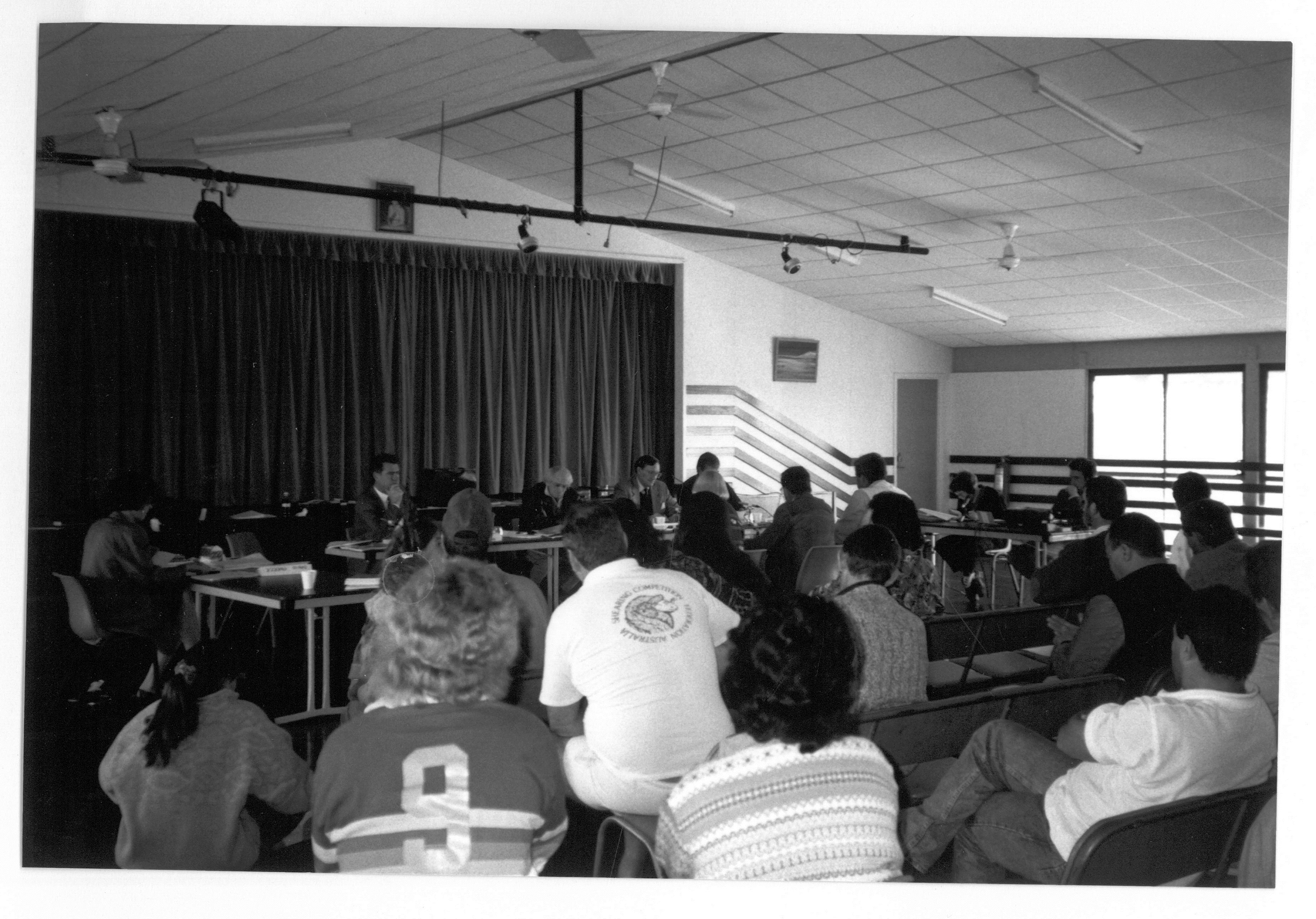 \x3cp\x3eStanding Committee on Rural and Regional Affairs at a public hearing in Muttaburra, Qld, of its inquiry into employment of visitors to Australia in the shearing industry, 6 June 1993. Seated facing camera L-R: Senators Jim McKiernan, Bryant Burns [Chair], David Brownhill [Deputy Chair] and Paul Calvert. Seated at witness table with backs to camera L-R: Witnesses Lorraine Fysh [Central and Northern Graziers Association], John Rutherford [Chair, Sheep and Wool Council, Central and Northern Graziers Association] and William Ballinger [Chair, Muttaburra Branch, Central and Northern Graziers Association].\x3c/p\x3e