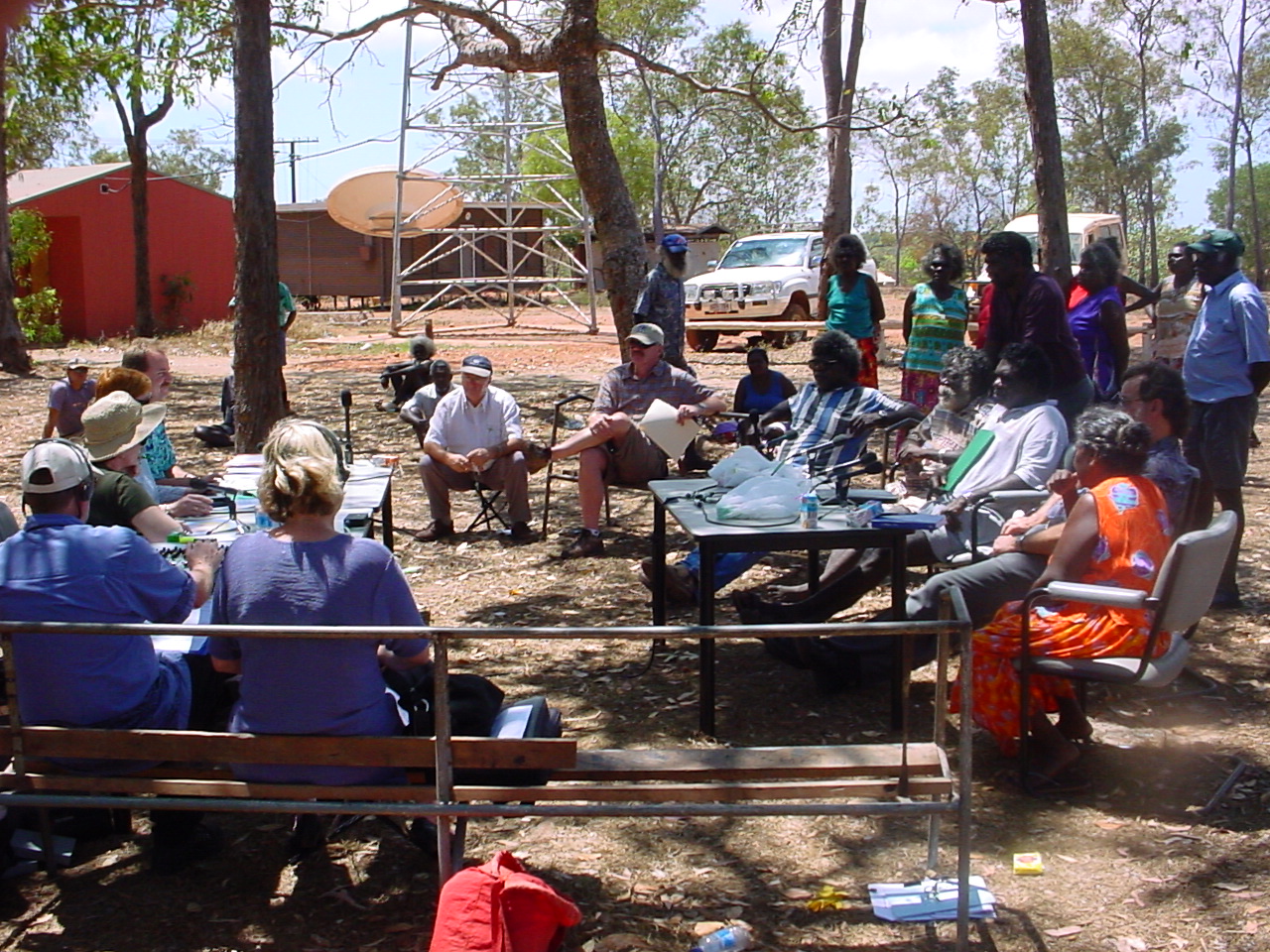 \x3cp\x3eElcho Island hearing, 11 September 2002. Seated at table on left, closest to farthest: Senators Ursula Stephens, Marise Payne [Acting Chair] and Nigel Scullion. Two Hansard editors seated with backs to camera. Witnesses seated and standing on right include Oscar Datjarrangu, Keith Djinyini, Richard Gandhuwuy, Joe Gumbula, Jeff Leggat [Council Clerk, Milingimbi Council], Roger McIvor [Manager, Marthakal Homelands Resource Centre], Jeffry Mulawa, Mike Netwon [Council Clerk, Galiwin\'ku Council], Terry Yumbilil and Charles Yunupingu.\x3c/p\x3e