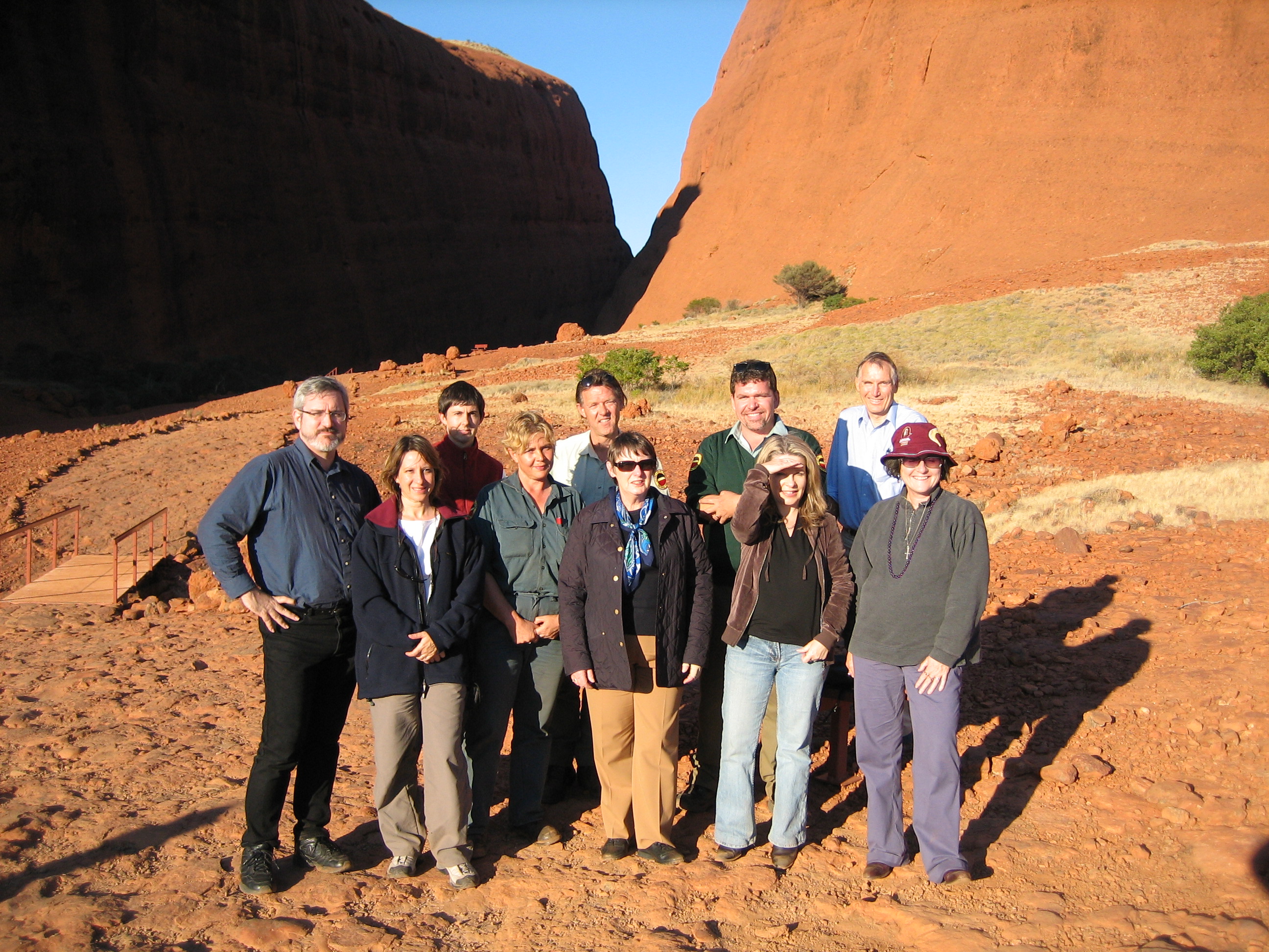 \x3cp\x3eCommittee members with Parks Australia staff during a site visit to Uluru-Kata Tjuta National Park as part of its inquiry into the funding and resources available to meet the objectives of Australia\'s national parks, other conservation reserves and marine protected areas, 27 June 2006. Back row L-R:  Senator Andrew Bartlett [Chair], Dr Ian Holland [Secretary] and three Parks Australia employees. Front row L-R: Dr Jacqueline Dewar [Acting Secretary], a Parks Australia employee, Senators Judith Adams [Deputy Chair], Dana Wortley and Claire Moore.\x3c/p\x3e