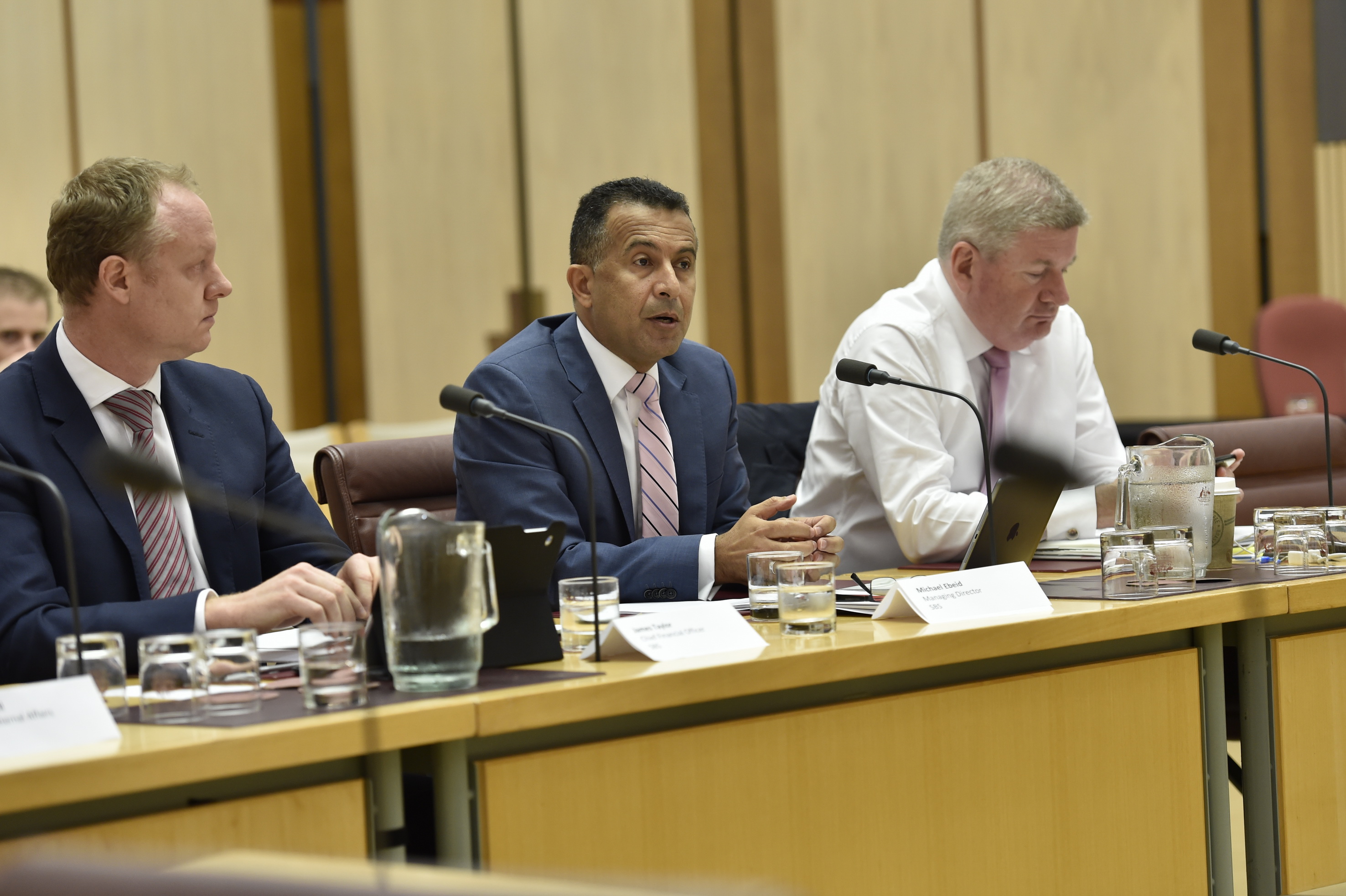 \x3cp\x3eOfficers from the Special Broadcasting Service (SBS) and Senator the Hon Mitch Fifield (right) appearing before the Environment and Communications Legislation Committee, 9 February 2016. DPS Auspic.\x3c/p\x3e
